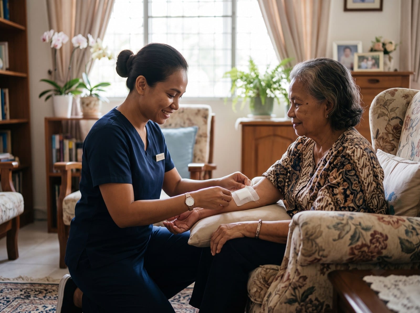 A nurse tending to an elderly patient's arm during a home nursing and wound care visit in Kota Kinabalu